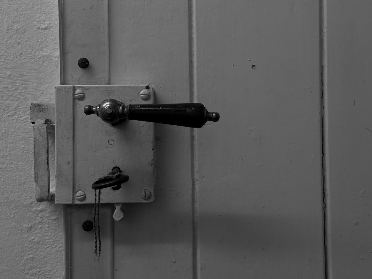 Door handle and rim lock with key in the keyhole